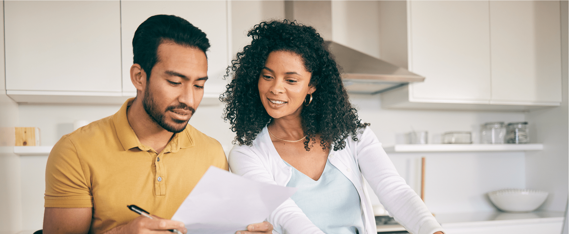 Couple reviewing documents in kitchen